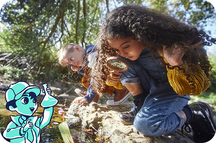 Two children kneel by a small stream outdoors, exploring the water with a magnifying glass, alongside an illustrated water scientist character.
